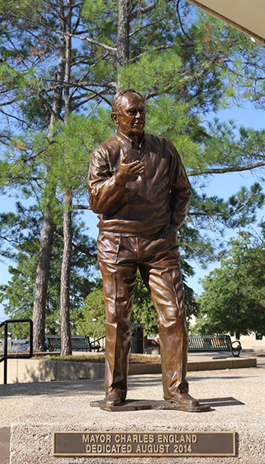 Mayor Charles V. England Sculpture - The life-size sculpture of former Grand Prairie Mayor Charles England commemorates his 21 years of service a a mayor. The bronze sculpture, installed outside of City Hall in August 2014, was commissioned and funded by the Grand Prairie Sports Facility Development Corporation, which England previously served as board member and president.